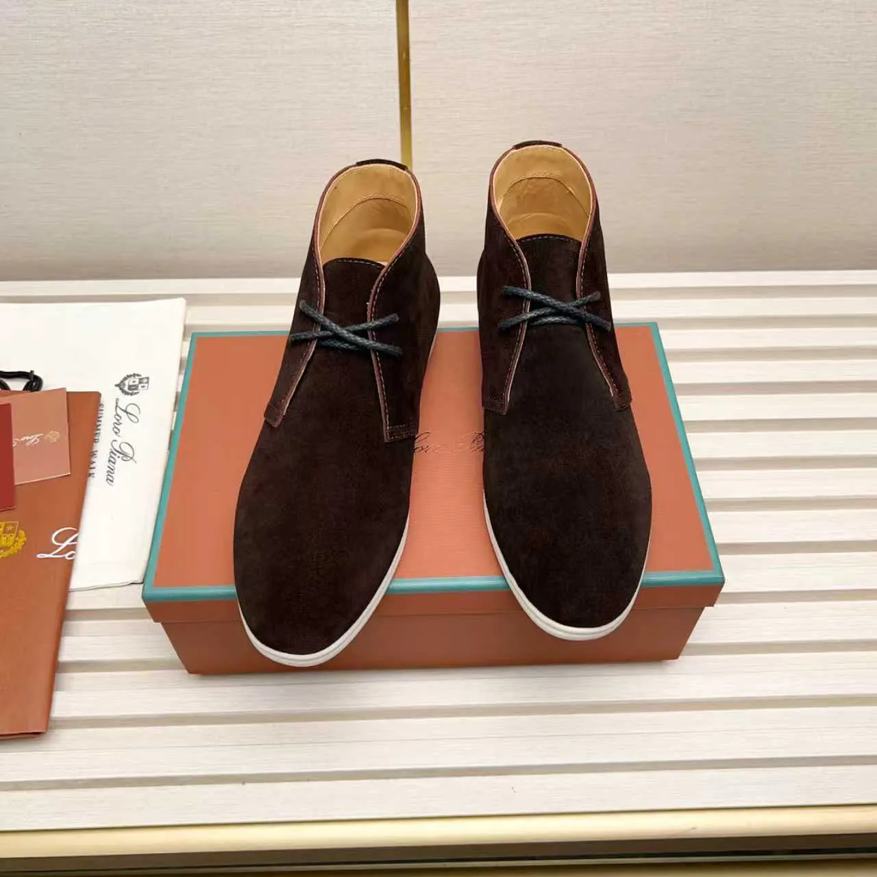 Men's Shoes 💰420 Loro Piana reimagines the desert boot—a modern, comfortable interpretation of a classic 1940s style. Crafted from suede calfskin, it exudes elegance. The tight texture of suede calfskin is not only durable but also looks casual and sophisticated. Add a timeless piece to your shoe collection, harmoniously blending comfort, style and Loro Piana's heritage of craftsmanship. Acetate satin detail on the inside White sole with LP lettering for added traction Space for a personalized signature on the heel Tonal suede trim Upper: 100% cow split suede Sole: 100% Rubber lining: Cow leather